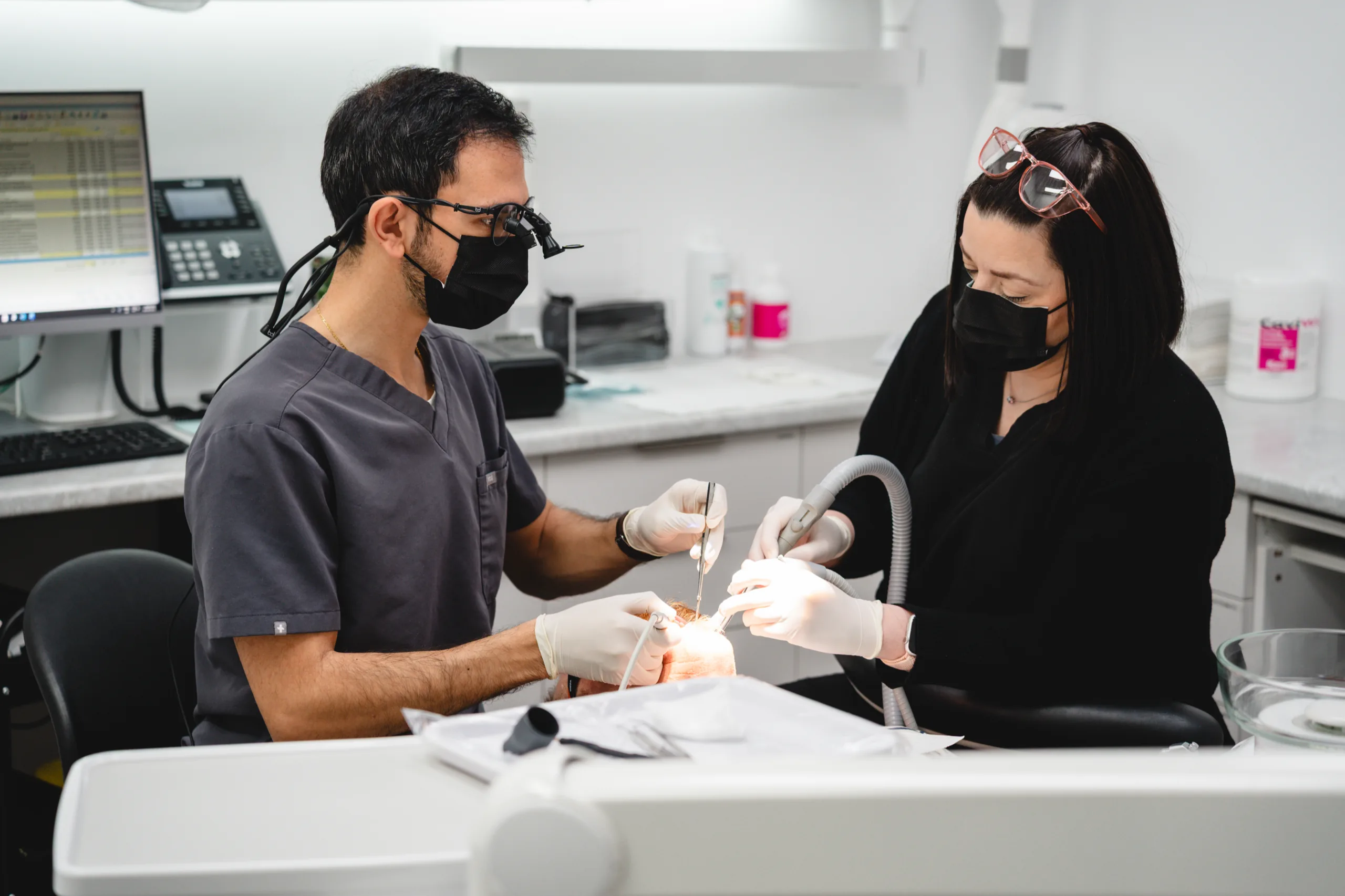 Dr Jose Shina and a dental assistant treating a patient at Dental Spot.